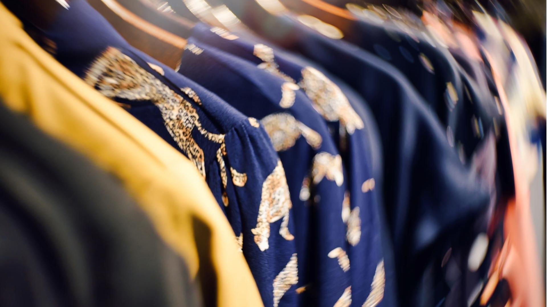 Close-up of clothes hanged in hangers in a shop near Titanic Mardan Palace