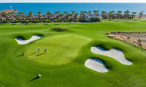 Aerial view of a greenery golf course field at Titanic Luxury Collection Bodrum