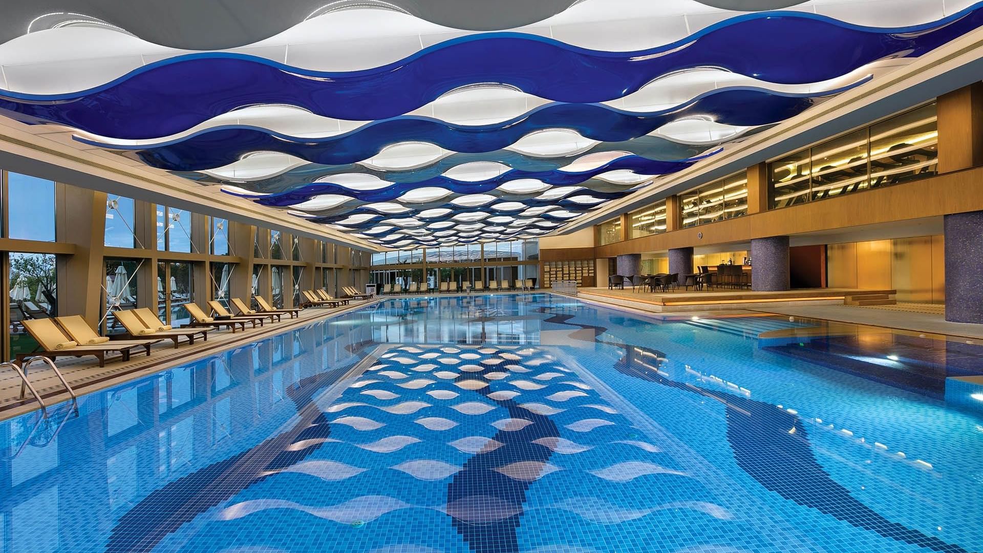 Well designed pool with cozy loungers in Indoor Pool Bar at Titanic Mardan Palace